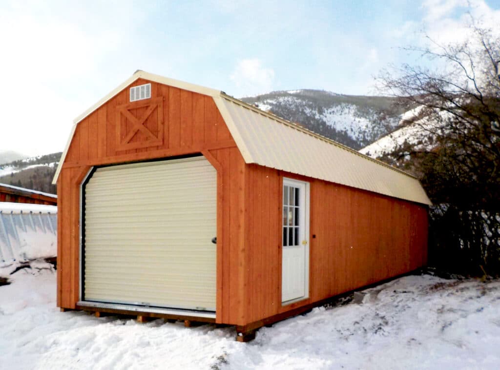 a red lofted garage in a winter setting from montana structures for sale in anaconda montana