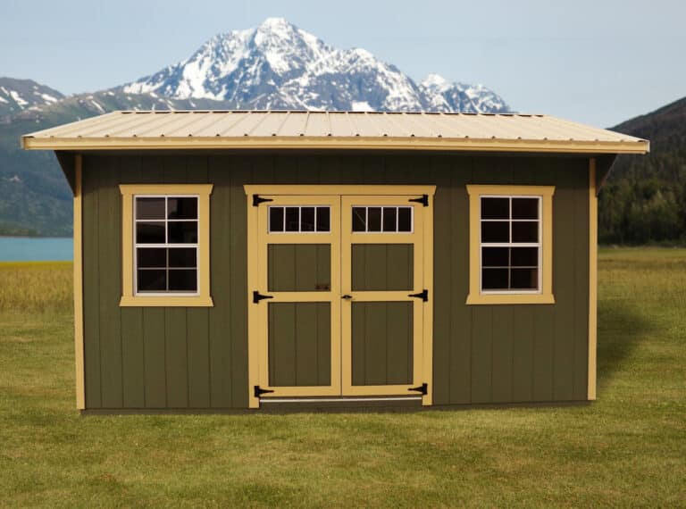 a photo of an anaconda shed from montana structures, dark green exterior and yellow trim